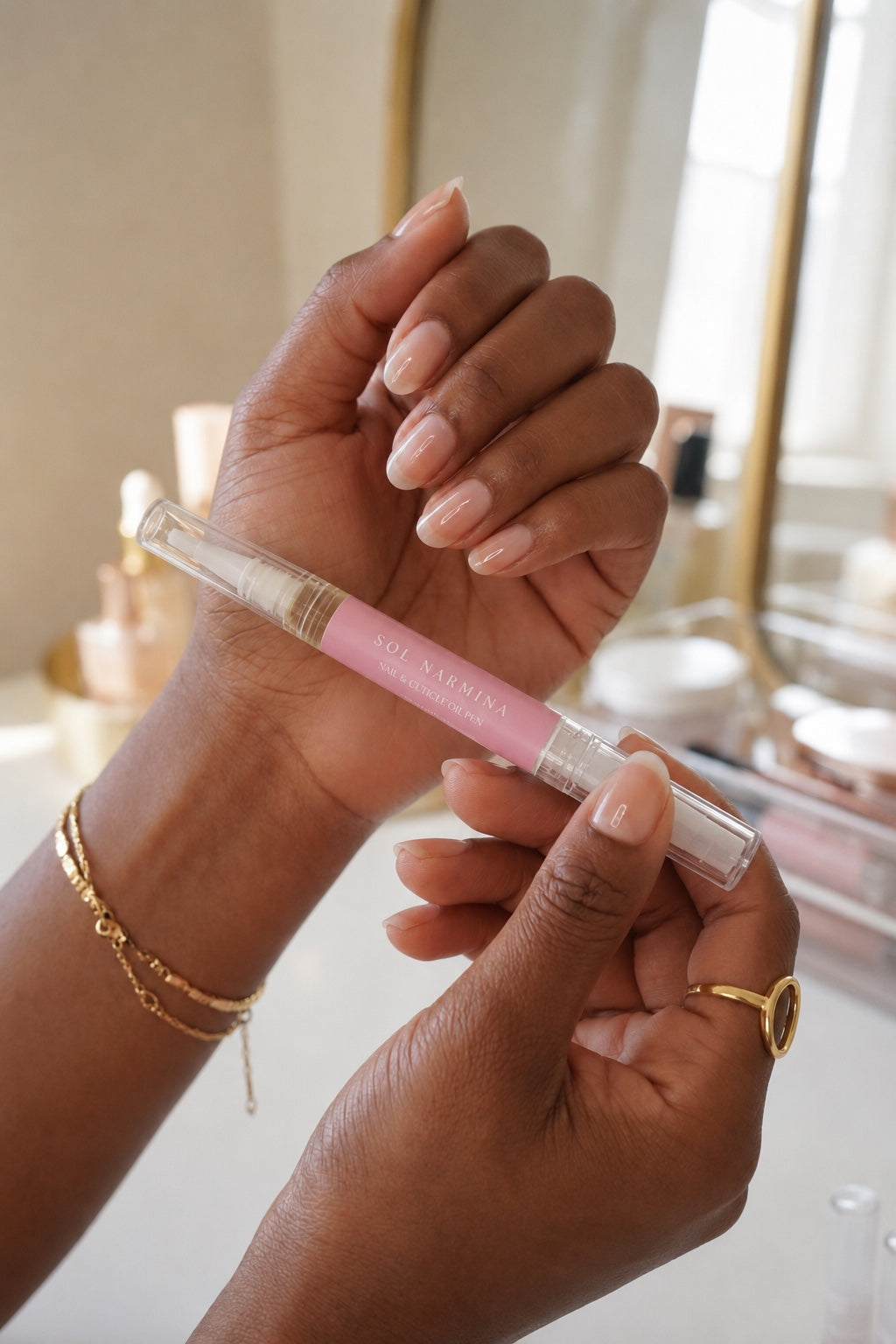 Sol Narmina Nail & Cuticle Oil Pen held in hand with manicured nails
